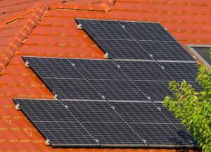 A contemporary building with a curved roof covered in solar panels