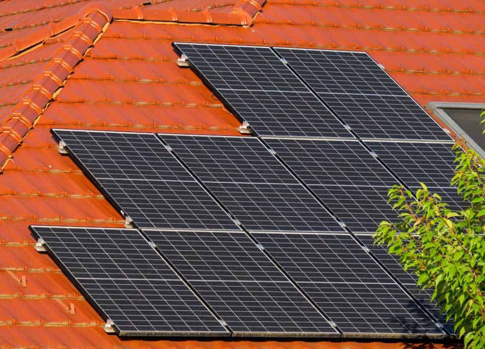 A contemporary building with a curved roof covered in solar panels